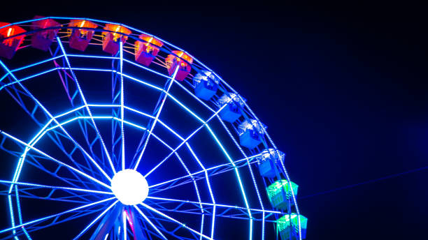 Night photo of a moving illuminated Ferris wheel in Madrid, Spain Unfocused on purpose with motion blur moving colorful Ferris wheel against the night sky at the Christmas fair Magicas Navidades in Torrejon de Ardoz, Madrid, Spain, the European Capital for Christmas ferris wheel photos stock pictures, royalty-free photos & images