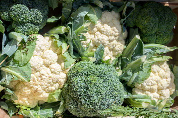 Organic cauliflower and broccoli in a box on the market, selected focus stock photo