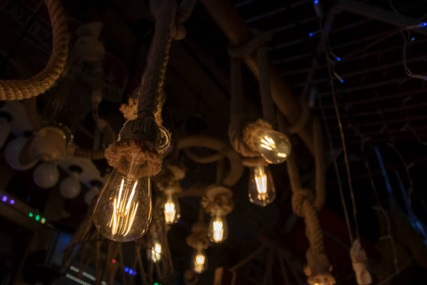istock Lamps hanging on rope, brown rope and yellow light 1174890738