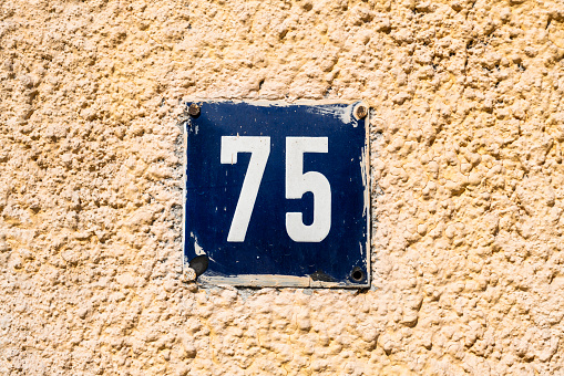 Street number sign on the wall