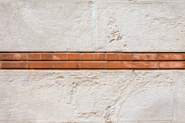 Stone wall with a line of bricks