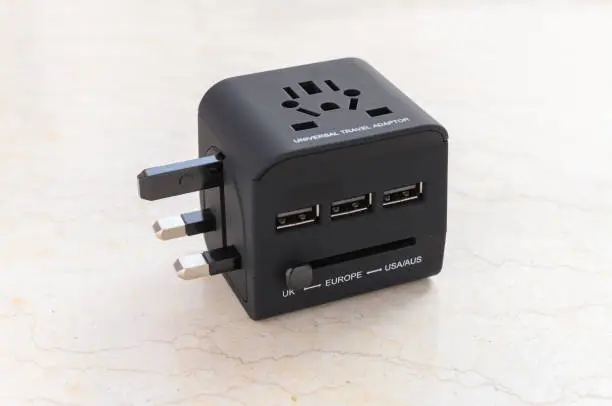 Photo of a brand new black universal adapter