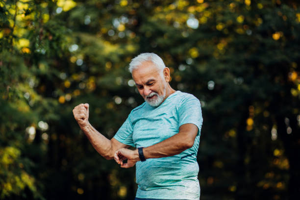 istock Senior man looking at his watch 1174894925