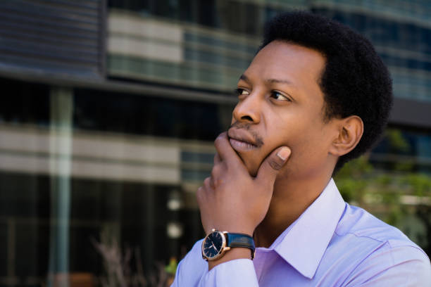 istock Focused businessman thinking in the city. 1174897358