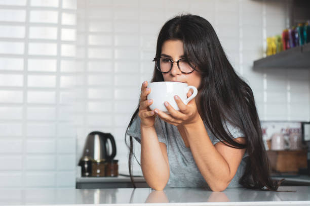 istock young woman drinking coffee at home 1174897388