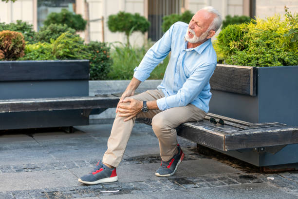 istock Senior Businessman with Knee Problems in the City Streets 1174898378