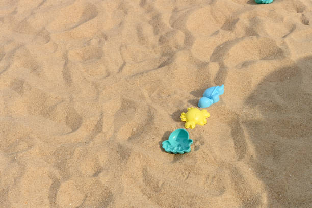 istock plastic playing things on sand in a sunny day 1174900554