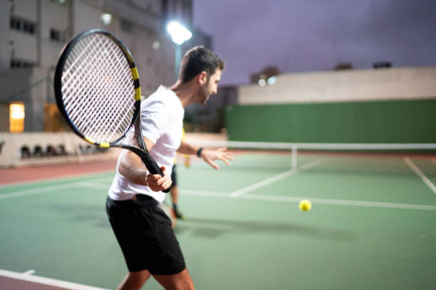 istock Teaching a guy how to play tennis 1174900575