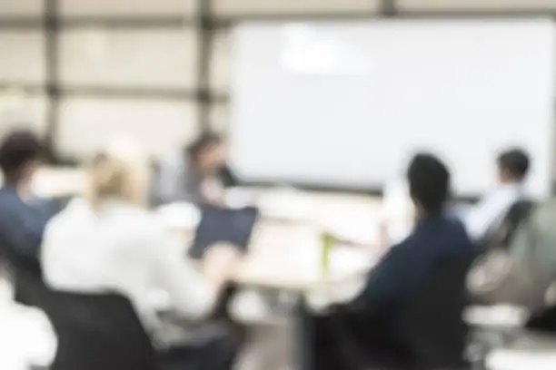 Photo of Blur office meeting background business people working group in discussion boardroom