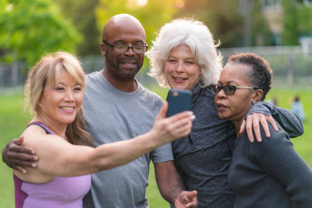 istock Multi-ethnic group of senior friends pose for selfie outside 1174902313