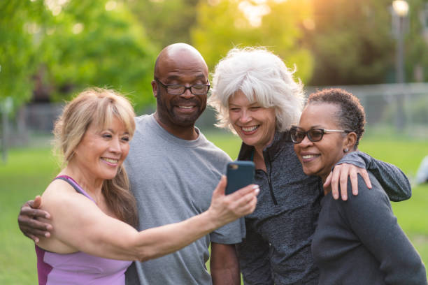 istock Multi-ethnic group of senior friends pose for selfie outside 1174902315