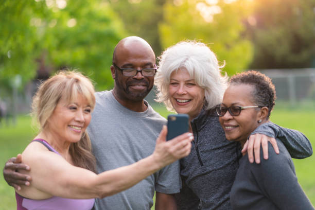 istock Multi-ethnic group of senior friends pose for selfie outside 1174902545