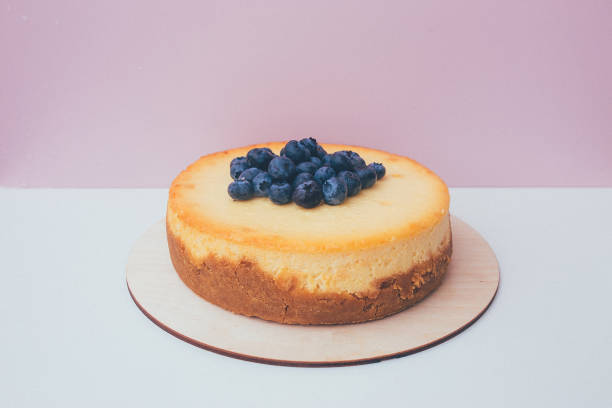 istock a cut of cake with whipped cream on the table background. 1174902554