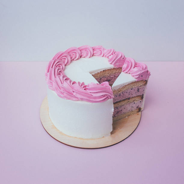 istock a cut of cake with whipped cream on the table background. 1174902561
