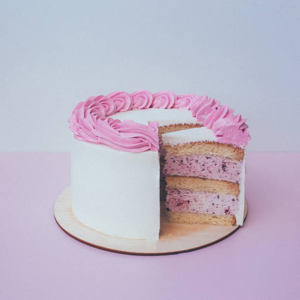 istock a cut of cake with whipped cream on the table background. 1174902654