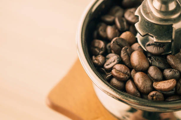 istock Vintage manual coffee grinder with roasted coffee beans 1174908511