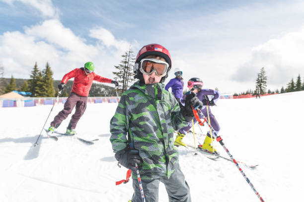 istock Elementary-age boy snow skiing with his family 1174914697