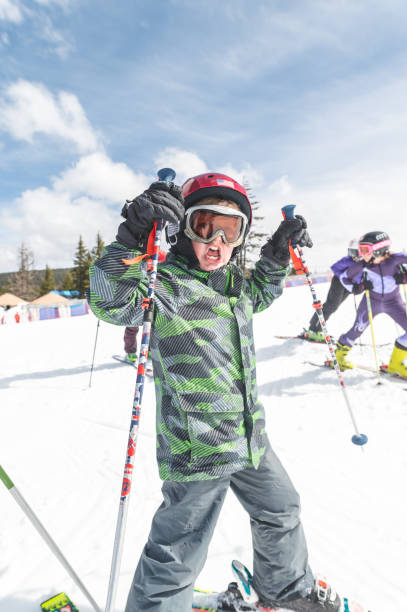 istock Elementary-age boy snow skiing with his family 1174914704