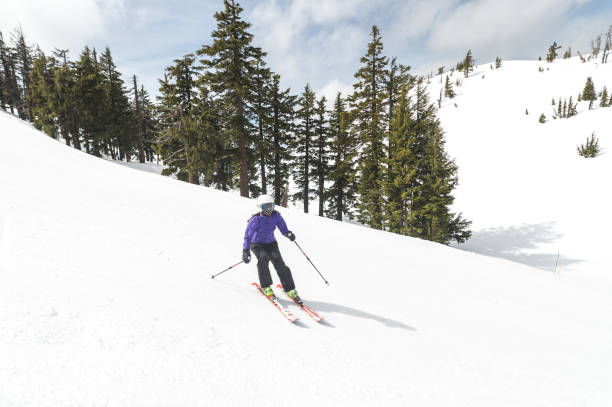 istock Female skiier pauses for a break partway down the mountain 1174914709
