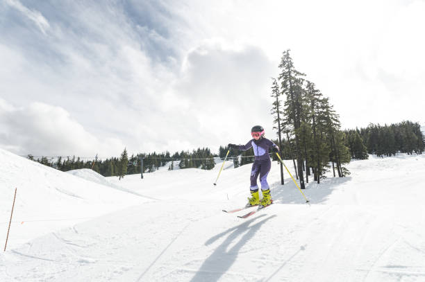 istock Girl skiing down a snowy mountain 1174914711