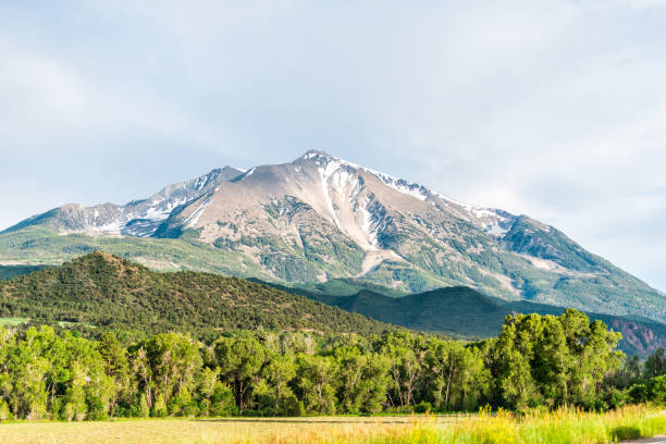 Mt Sopris mountain in Carbondale, Colorado town view with snow mountain peak and sky in summer during sunset Mt Sopris mountain in Carbondale, Colorado town view with snow mountain peak and sky in summer during sunset basalt photos stock pictures, royalty-free photos & images