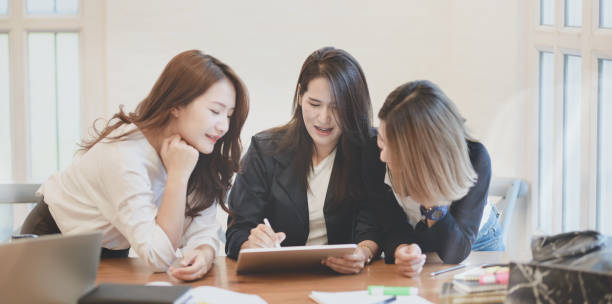 istock Professional female freelancer explaining her idea concepts to her team members 1174920155