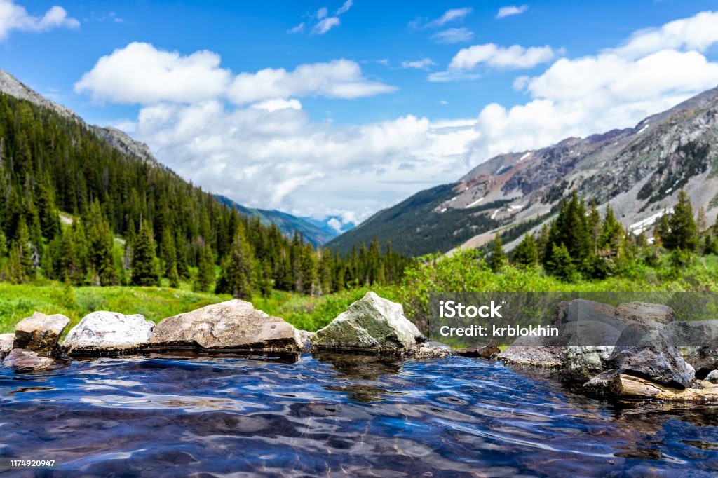 Hot springs blue pool on Conundrum Creek Trail in Aspen, Colorado in 2019 summer with rocks stones and valley view with nobody Colorado Stock Photo