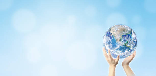 istock Hand holding blue planet earth globe with blurred bokeh background. 1174921765