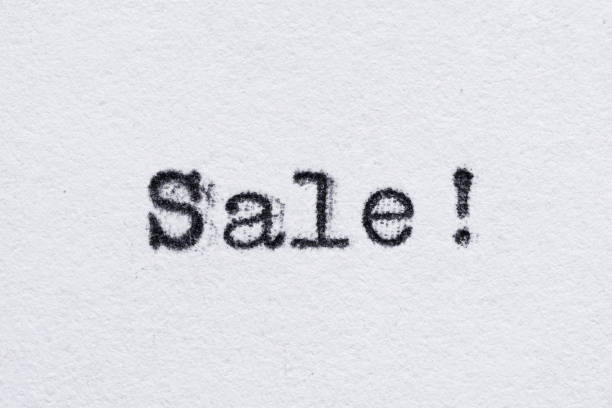 istock Sale word on white paper printed with typewriter 1174921912