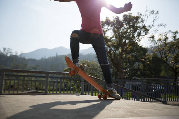 istock Skateboarder skateboarding at skatepark ramp 1174922974