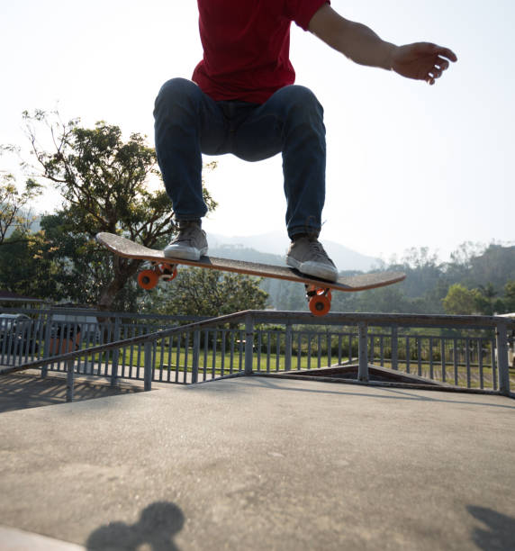 istock Skateboarder skateboarding at skatepark ramp 1174922988
