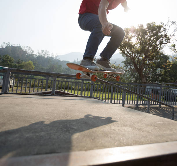 istock Skateboarder skateboarding at skatepark ramp 1174923024