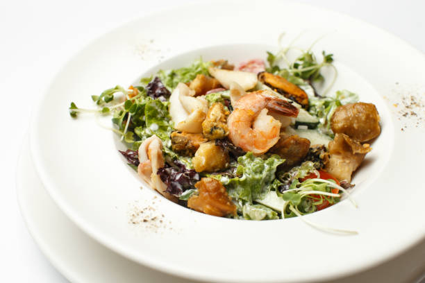 istock seafood with vegetables in a white plate 1174924259