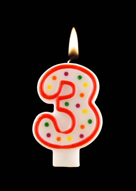 istock Burning birthday candle isolated on black, number 3 1174928432