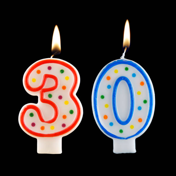 istock Burning birthday candle isolated on black, number 30 1174928471