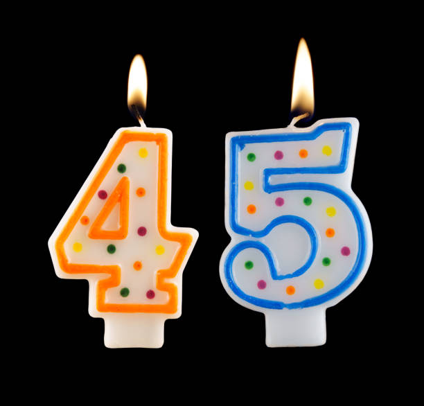 istock Burning birthday candle isolated on black, number 45 1174928598
