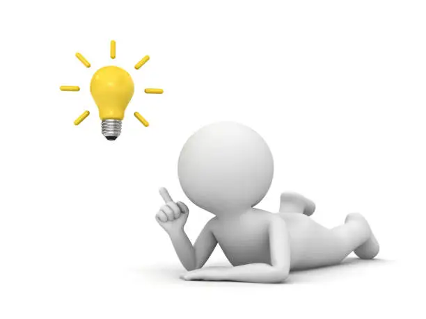 Photo of 3d man lying on his stomach and pointing finger to the bright idea bulb isolated over white background with shadow