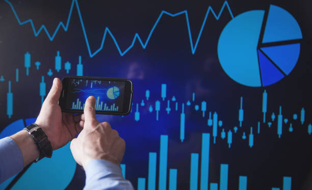Businessman working in financial graphs in screen.