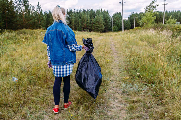 istock woman with a large garbage bag 1174934991