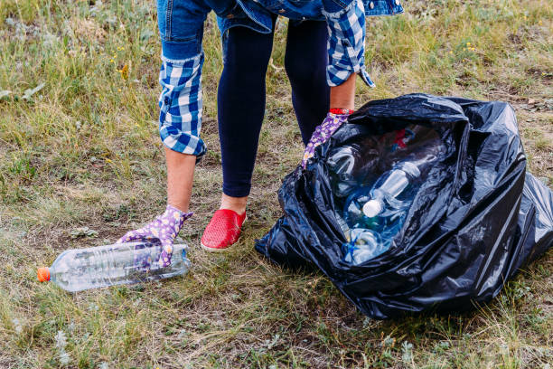 istock the woman in the denim jacket clears the environment from plastic waste. 1174935006