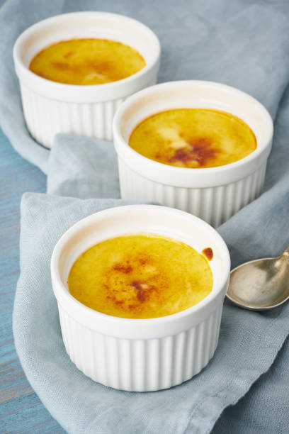 istock Crema catalana, Spanish dessert in three ramekin on blue table, vertical 1174935261