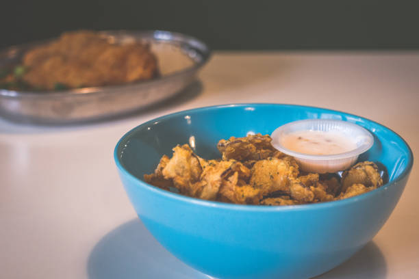 istock thinly sliced eggplant battered and deep fried then served with sweet mayonnaise in a blue bowl 1174937747