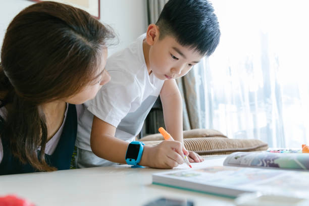 istock Asian mother and son doing homework. 1174937810