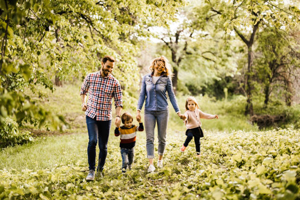istock Young carefree family having fun while running in the forest. 1174937931