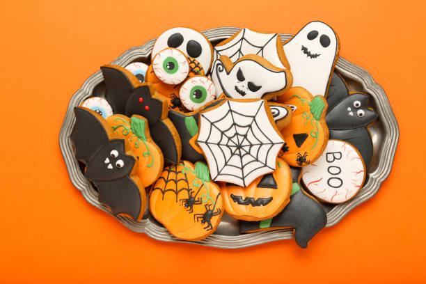 istock Halloween gingerbread cookies on orange background 1174939845