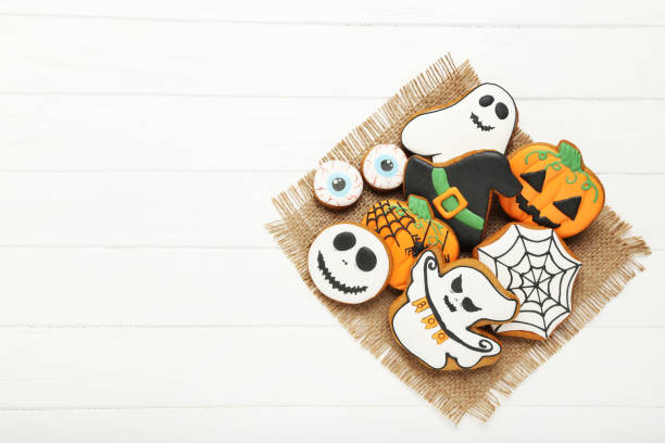 istock Halloween gingerbread cookies on white wooden table 1174939863