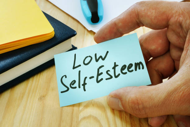 istock Low Self esteem sign in the hand. 1174940267