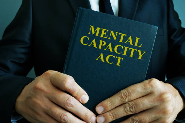 Man is holding mental capacity act. Man is holding mental capacity act. cerebrum photos stock pictures, royalty-free photos & images