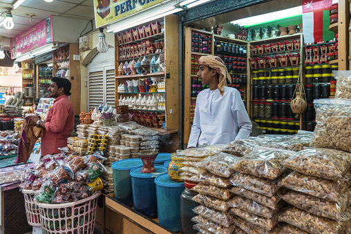 Salalah, Sultanat of Oman - November 12, 2017: Bazaar merchants selling frankincense and other goods at the Souq in Salalah, Oman, Indian Ocean. This souk is the biggest frankincense souk in southern Oman.
