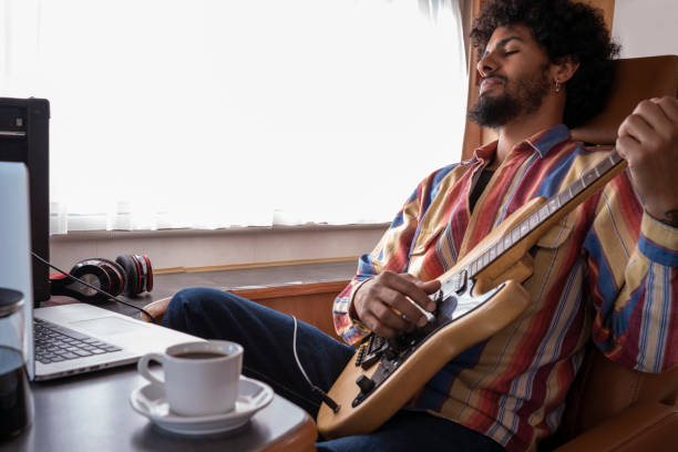 istock Digital Nomad young man guitar player in motorhome 1174941551